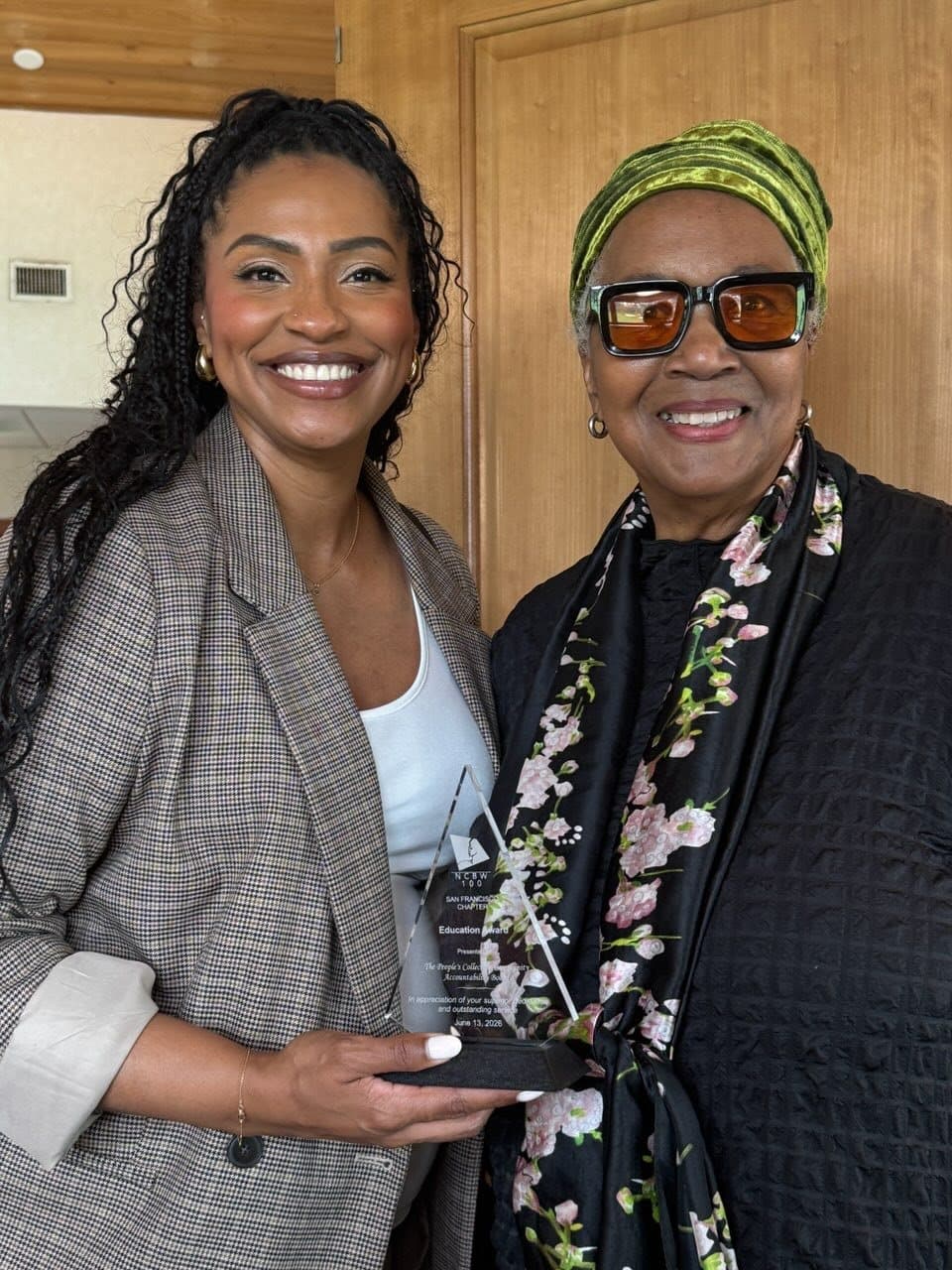 Two members of The People’s Collective holding the NCBW San Francisco Chapter Education Award