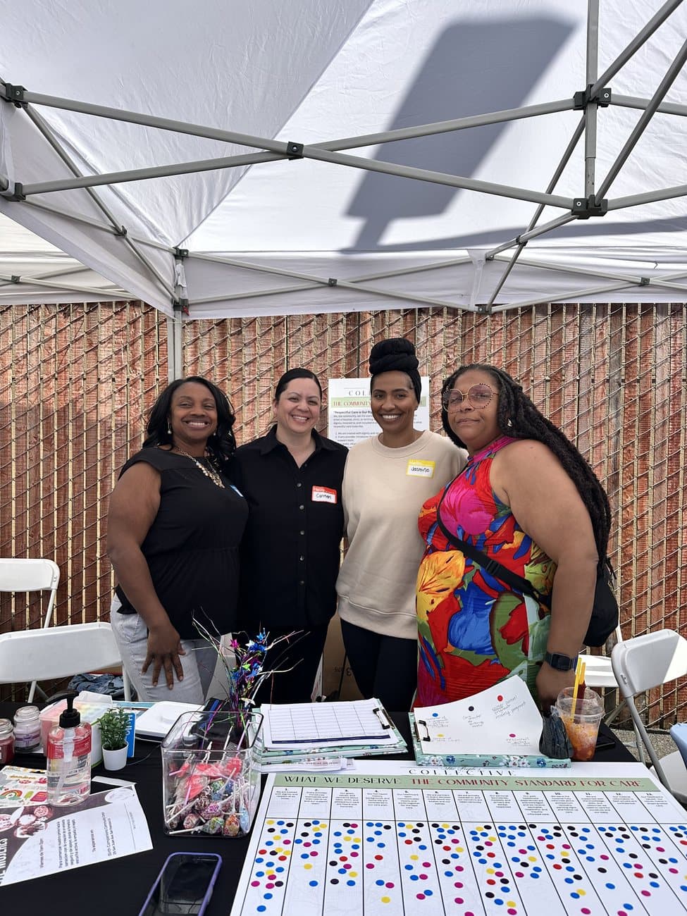 CAB members greeting families at The People’s Collective community resource table